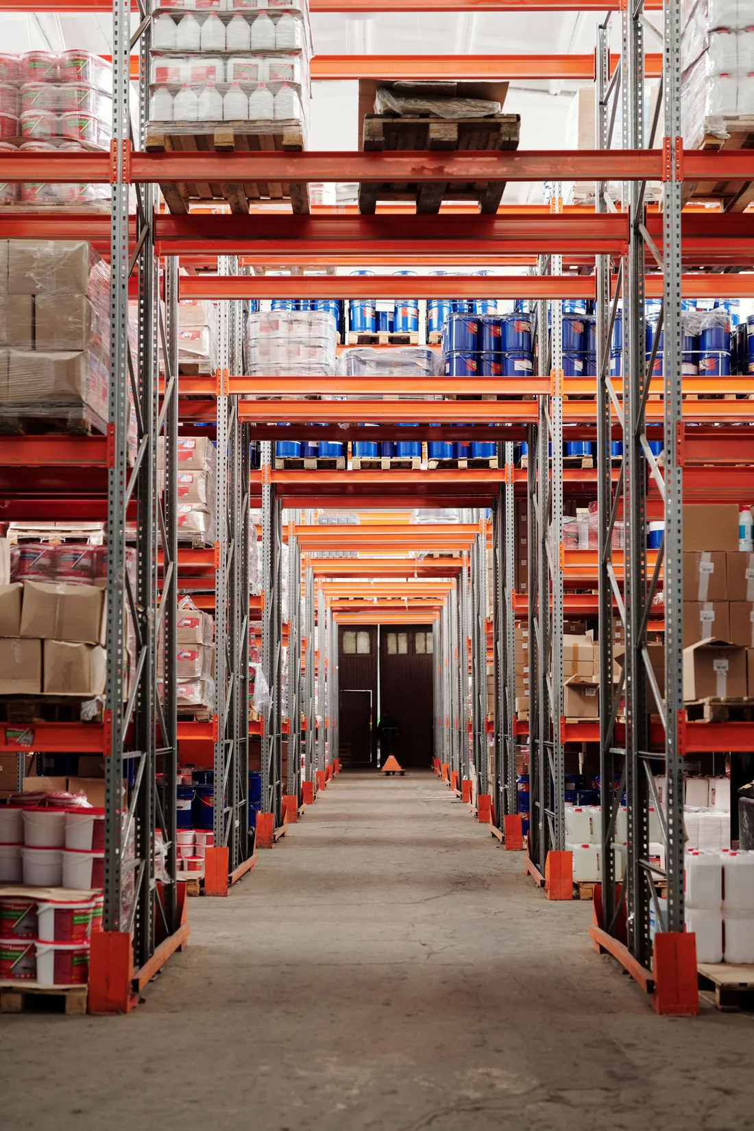 Tall warehouse aisles holding packaged and palletized goods